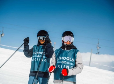 Two pupils in Schools Go Skiing bibs ready to ski